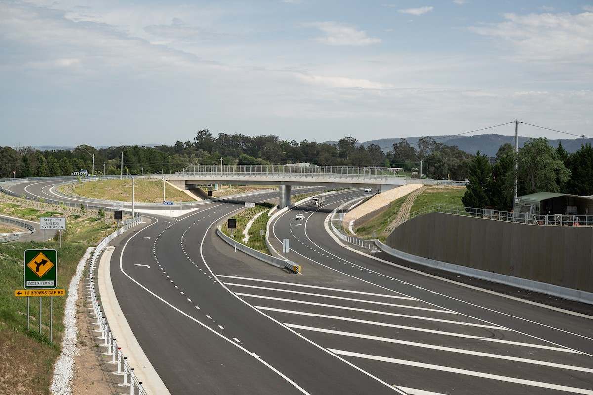 Completed motorway interchange threading through bushland