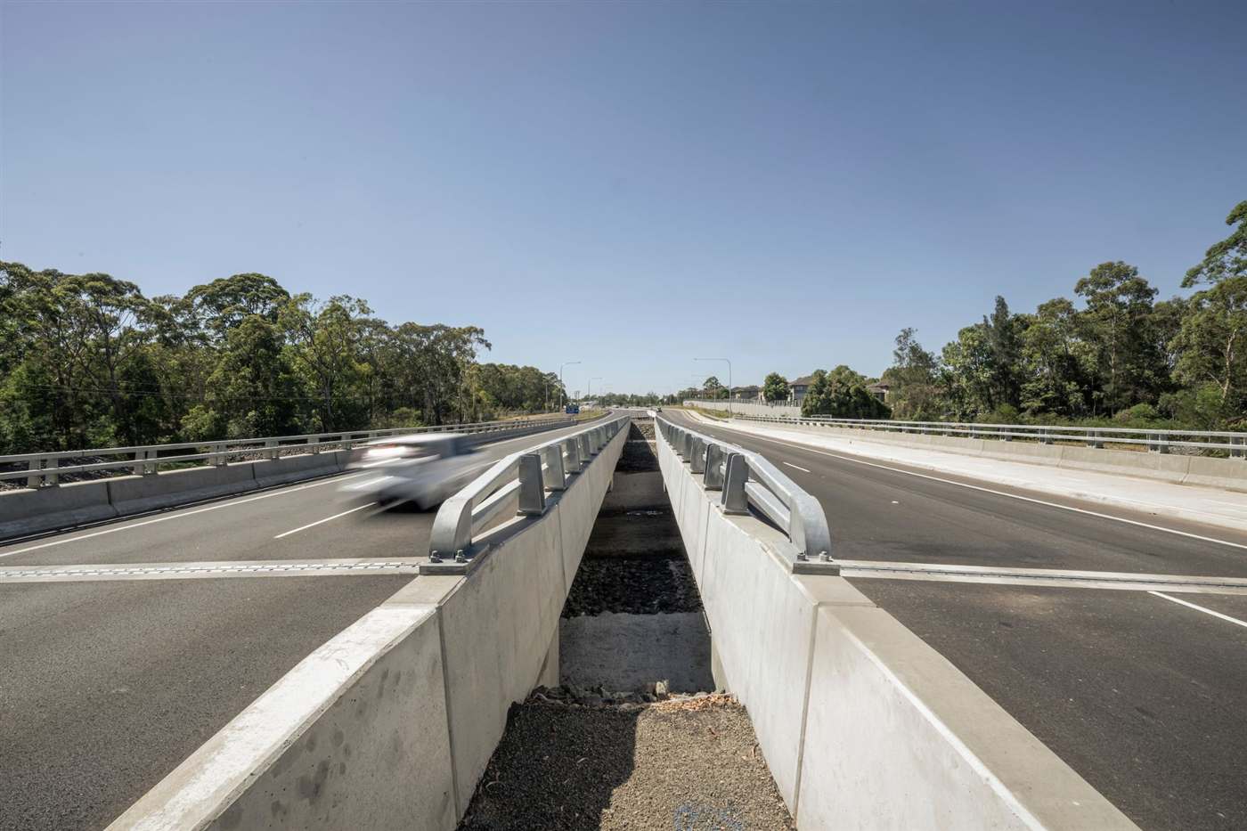 New twin road bridges carrying the upgraded parkway through bushland